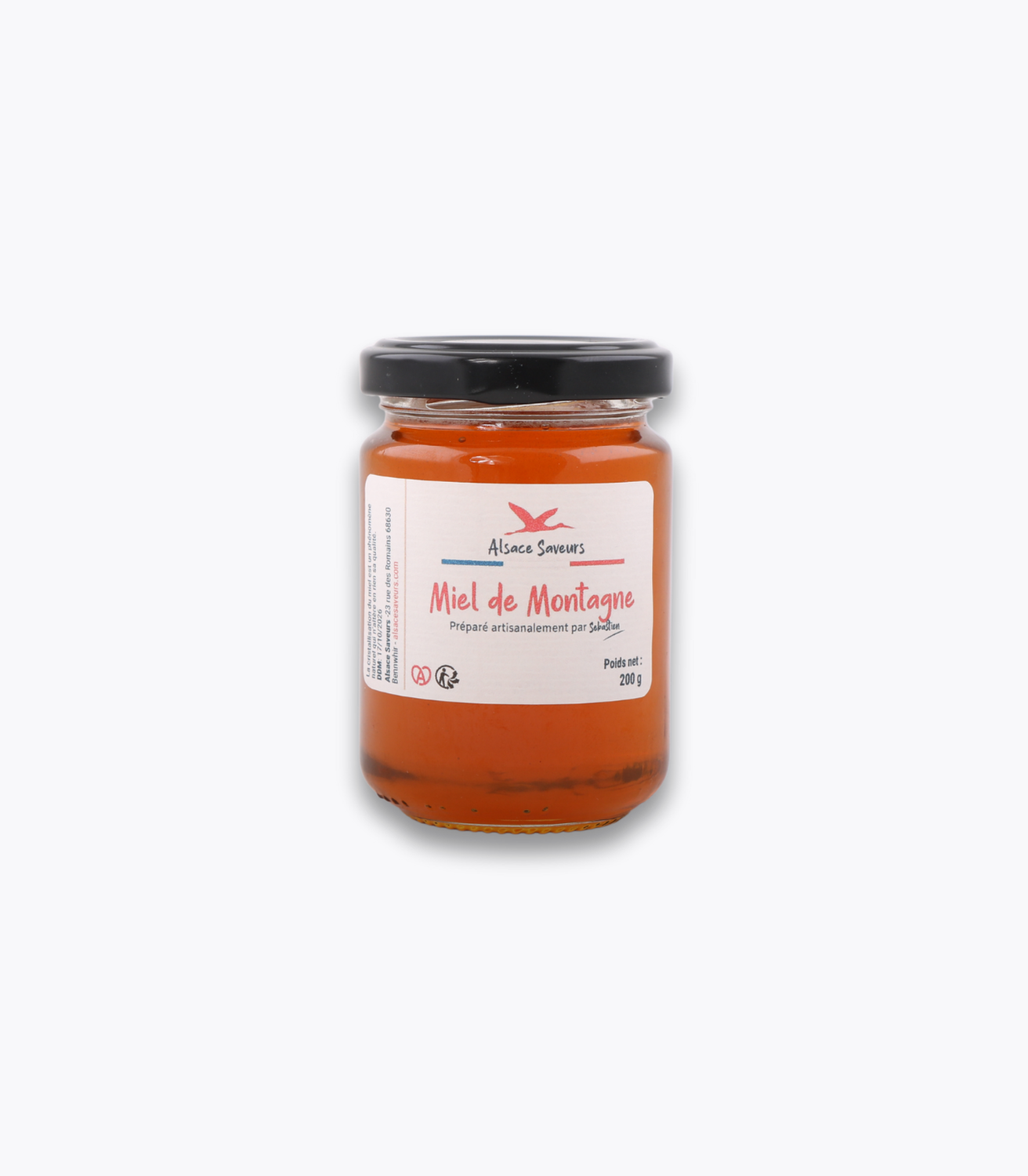 pot de miel de montagne sur fond gris